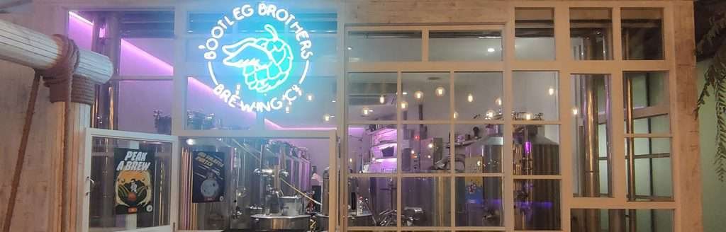 Picture of the glass wall in front of the brewing equipment of Bootleg Brothers Brewpub in Bangkok Thailand. 