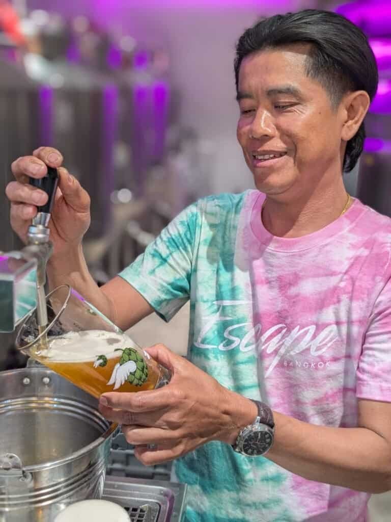 Staff serving a beer at Bootleg Brothers Brewpub in Bangkok Thailand. 