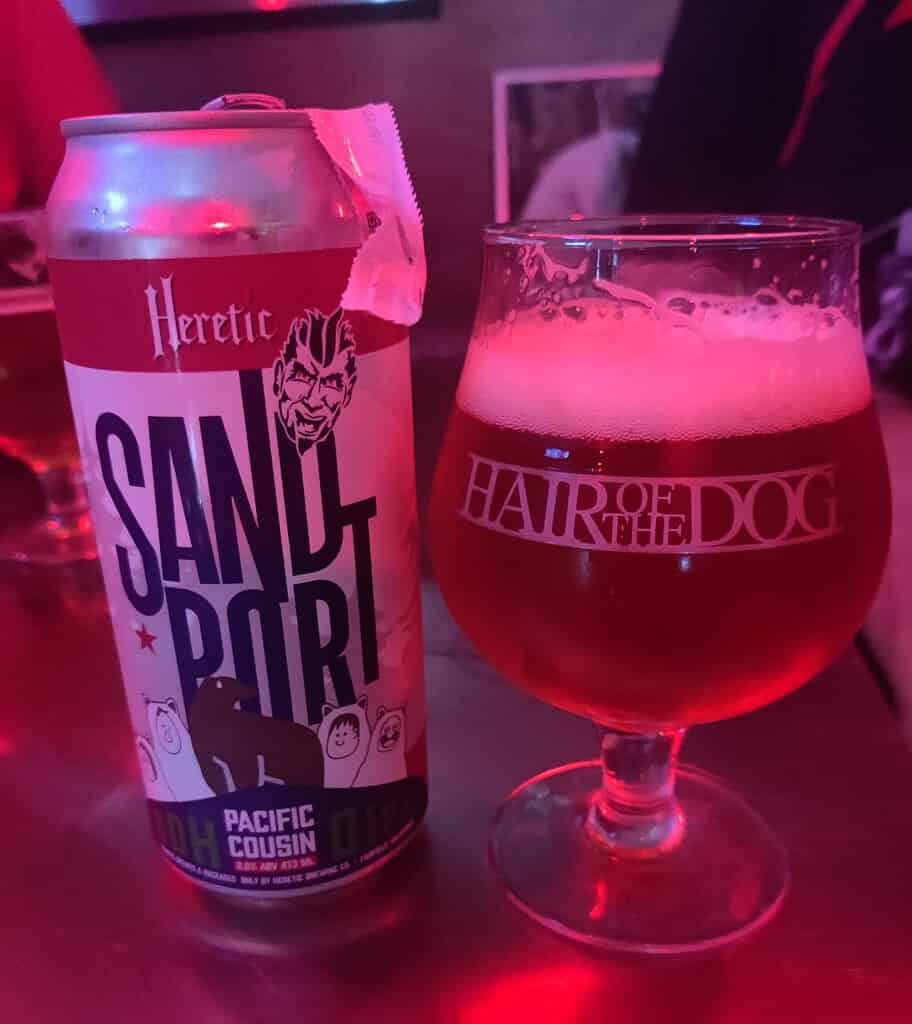 Hair of the Dog craft beer bar in Phloen Chit Bangkok Thailand.
Tall can of collaboration brew of Heretic and Sandport Brewing.