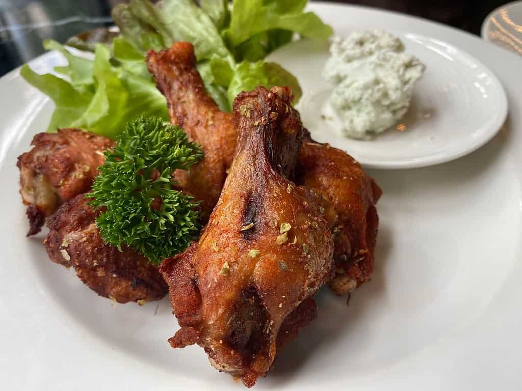 Chicken wings at Burbrit Craft Beer bar in Bangkok Thailand. Beer from Burma, served in the Thai Capital. 