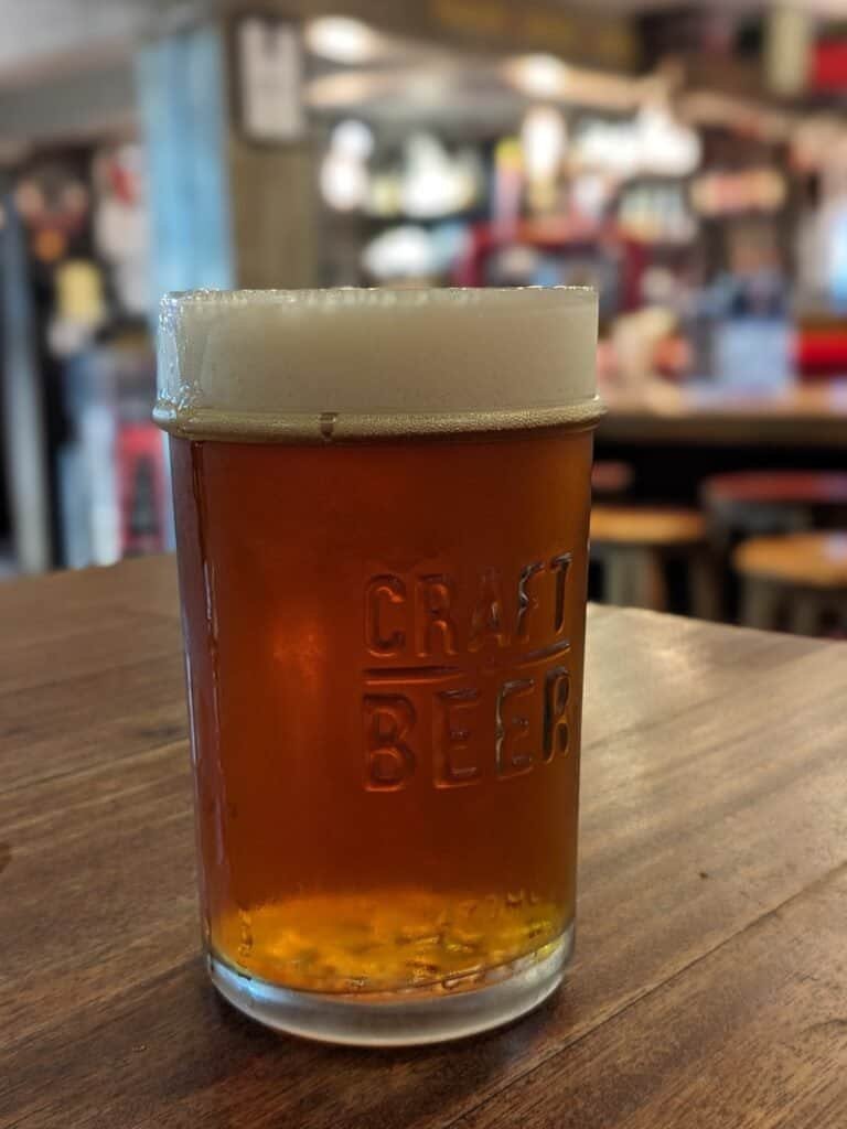 Rogue craft beer in a Craft Beer embossed pint glass on a wooden table at Billy's Smokehouse Craft beer bar and barbeque
