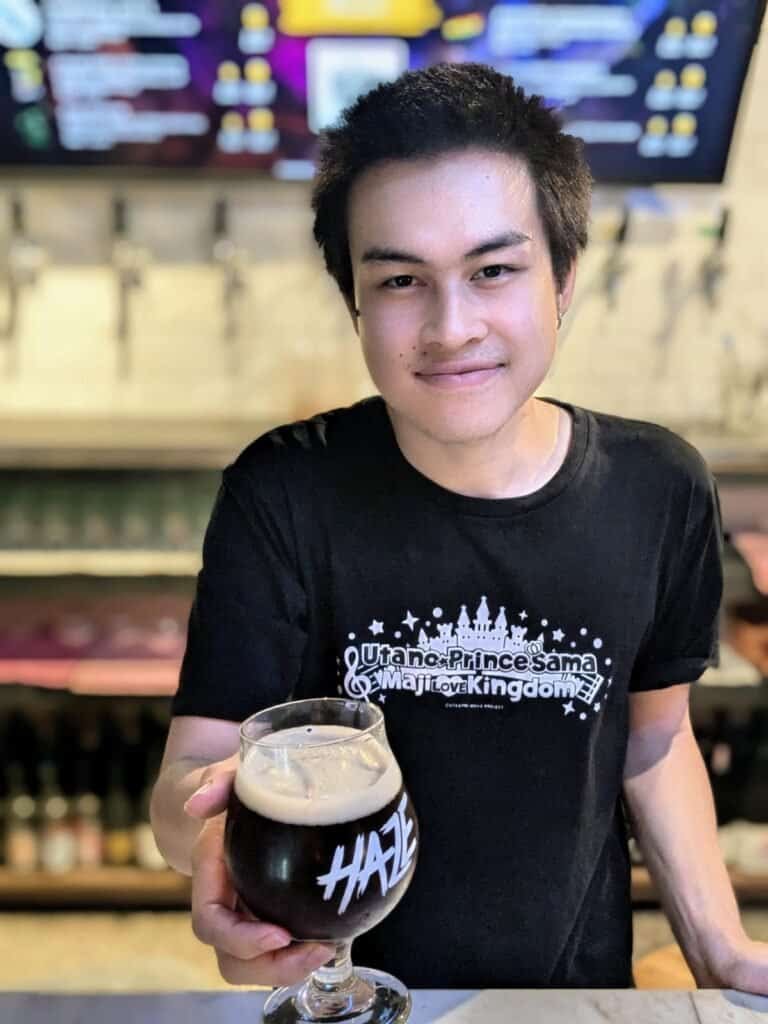 Staff serving a beer in a goblet at Haze bar in Bangkok's Chinatown, Thailand.