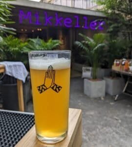 Mikkeller Bangkok branded glass in front of the bar